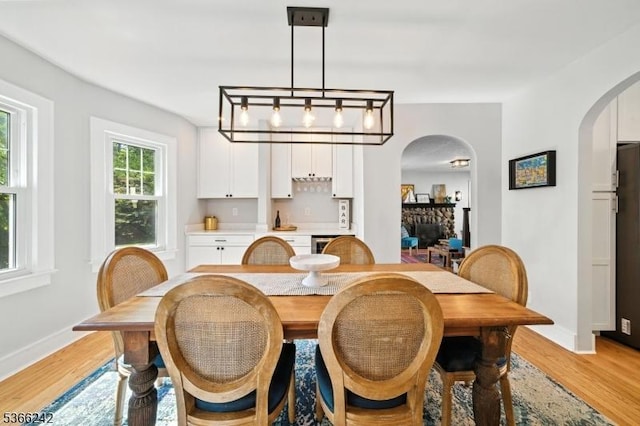 86 Riverside Dr, Denville Twp, NJ 07834 - dining room featuring arched walkways and light wood finished floors
