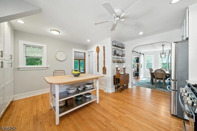 86 Riverside Dr, Denville Twp, NJ 07834 - dining space featuring light wood finished floors, ceiling fan, recessed lighting, and arched walkways