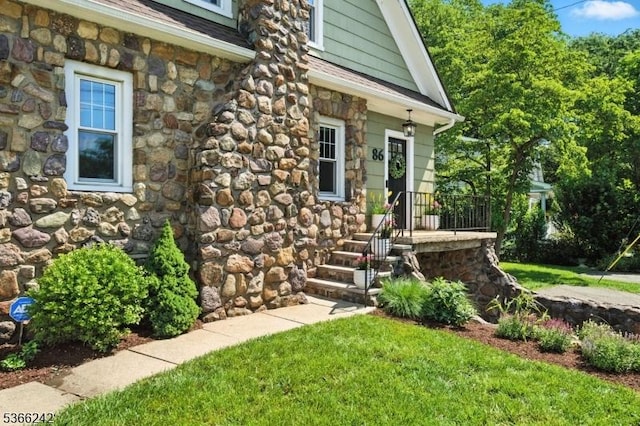 86 Riverside Dr, Denville Twp, NJ 07834 - doorway to property with stone siding, a lawn, and roof with shingles