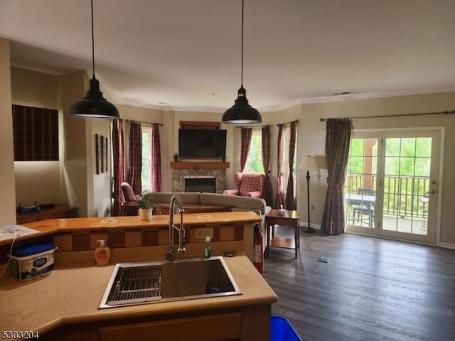 7-11 Maple Cres Unit 11, Vernon Twp, NJ 07462 - kitchen featuring light countertops, a stone fireplace, open floor plan, healthy amount of natural light, and crown molding