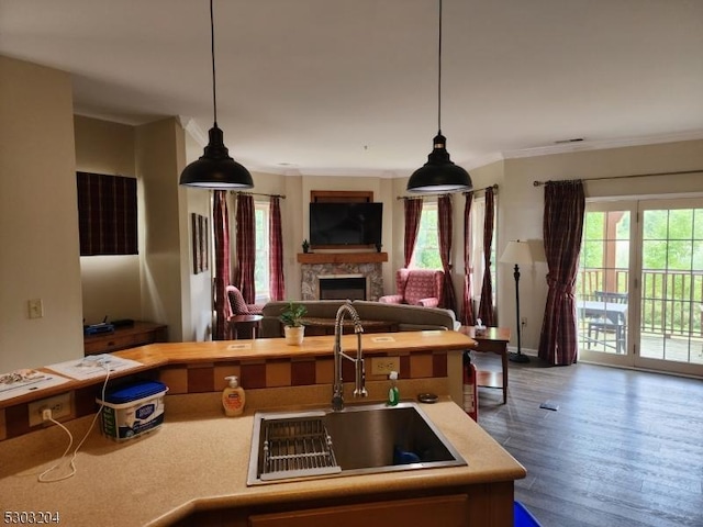 7-11 Maple Cres Unit 11, Vernon Twp, NJ 07462 - kitchen featuring open floor plan, a fireplace, light countertops, crown molding, and decorative light fixtures