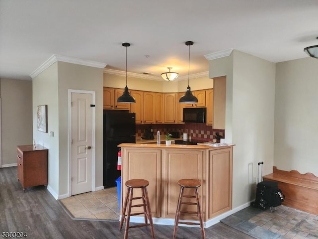 7-11 Maple Cres Unit 11, Vernon Twp, NJ 07462 - kitchen with black appliances, a peninsula, wood finished floors, backsplash, and ornamental molding