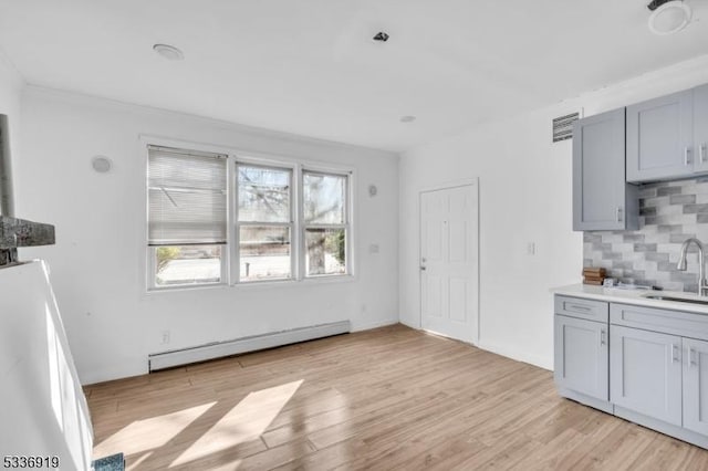 797 Passaic Ave, West Caldwell Twp, NJ 07006 - kitchen featuring a baseboard radiator, tasteful backsplash, light wood-style flooring, and gray cabinetry