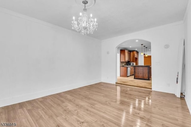 797 Passaic Ave, West Caldwell Twp, NJ 07006 - unfurnished living room with arched walkways, a chandelier, ornamental molding, and light wood-style flooring