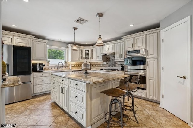 1127 Mountain Ave, Berkeley Heights Twp, NJ 07922 - kitchen with appliances with stainless steel finishes, decorative backsplash, a kitchen island, a breakfast bar, and recessed lighting