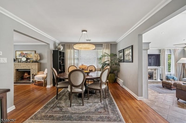 1127 Mountain Ave, Berkeley Heights Twp, NJ 07922 - dining room featuring a stone fireplace, a baseboard heating unit, ornamental molding, and wood finished floors