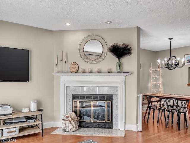 2904 Pinhorn Dr, Bridgewater Twp, NJ 08807 - living area featuring a high end fireplace, a textured ceiling, wood finished floors, a chandelier, and recessed lighting