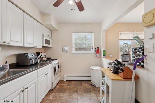 1245B Valley Rd Unit B, Wayne Twp, NJ 07470 - kitchen with a baseboard radiator, white appliances, a ceiling fan, stone finish floors, and white cabinets
