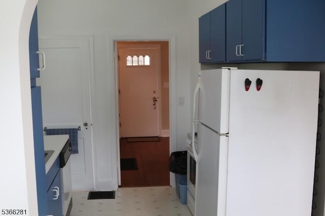 2132 Alberta Ave, Linden City, NJ 07036 - kitchen featuring freestanding refrigerator, blue cabinets, arched walkways, and light floors