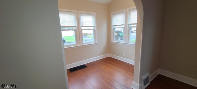 2132 Alberta Ave, Linden City, NJ 07036 - empty room featuring arched walkways and dark wood-style flooring