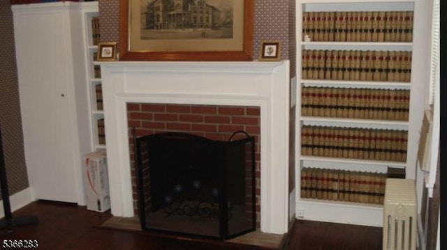 51 High St, Newton Town, NJ 07860 - detailed view of a brick fireplace and wood finished floors