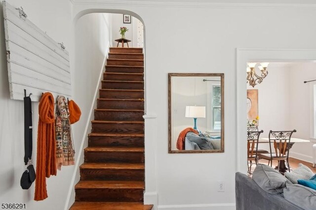 64 Rollinson St, West Orange Twp, NJ 07052 - stairs with arched walkways, a chandelier, and wood finished floors