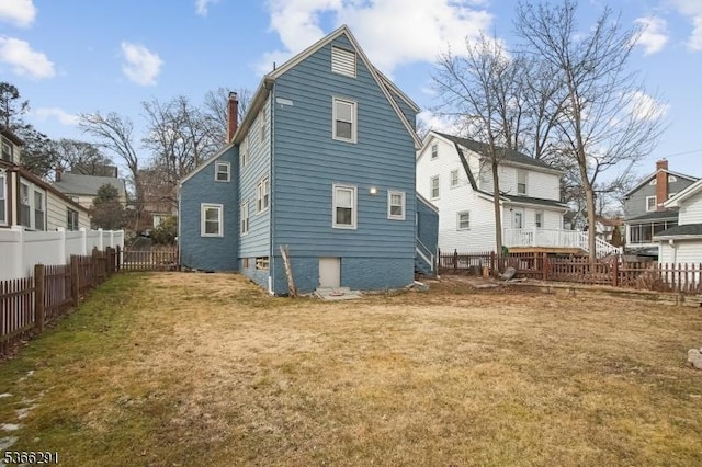 64 Rollinson St, West Orange Twp, NJ 07052 - back of property with a chimney and a fenced backyard