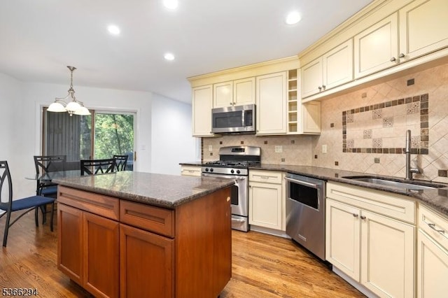 29 Stonegate Dr, Watchung Boro, NJ 07069 - kitchen featuring appliances with stainless steel finishes, cream cabinetry, a chandelier, tasteful backsplash, and light wood-style floors