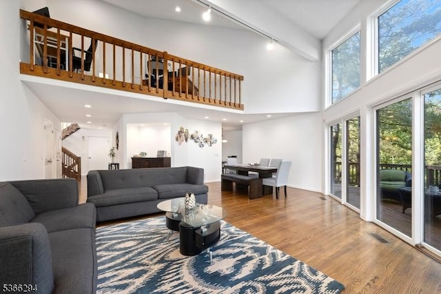 29 Stonegate Dr, Watchung Boro, NJ 07069 - living area with a high ceiling, wood finished floors, rail lighting, and stairway