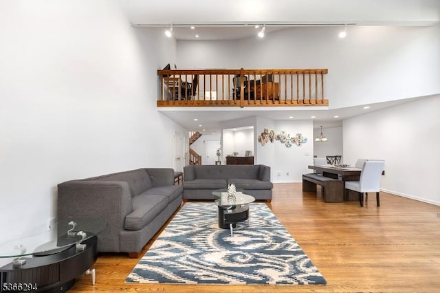 29 Stonegate Dr, Watchung Boro, NJ 07069 - living area featuring track lighting, wood finished floors, a high ceiling, and stairs