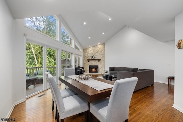29 Stonegate Dr, Watchung Boro, NJ 07069 - dining room with high vaulted ceiling, a stone fireplace, and wood finished floors