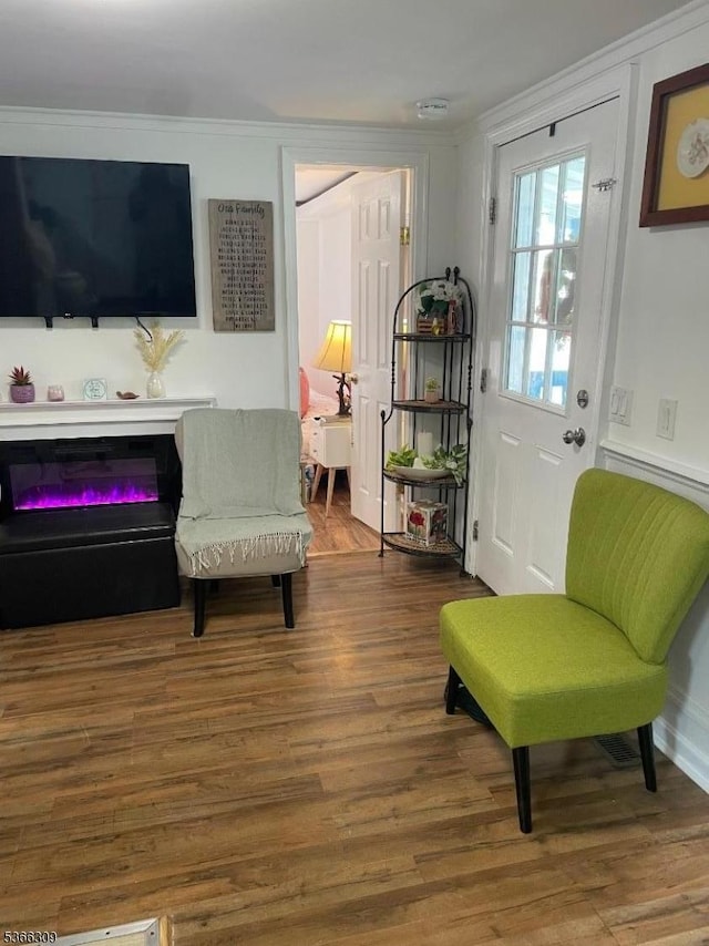 16 Sale St, Moonachie Boro, NJ 07074 - living area featuring wood finished floors, ornamental molding, and a glass covered fireplace