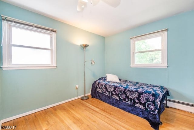 34 Copperfield Rd, Scotch Plains Twp, NJ 07076 - bedroom featuring wood finished floors, a baseboard radiator, and a ceiling fan
