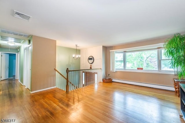 34 Copperfield Rd, Scotch Plains Twp, NJ 07076 - empty room with baseboard heating, attic access, wood finished floors, and a chandelier