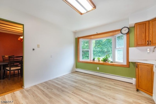 34 Copperfield Rd, Scotch Plains Twp, NJ 07076 - unfurnished dining area featuring a baseboard radiator, light wood-style flooring, and a chandelier