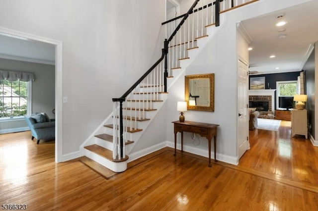 8 Forest Dr, Morris Twp, NJ 07960 - stairway featuring crown molding, wood finished floors, a brick fireplace, and recessed lighting