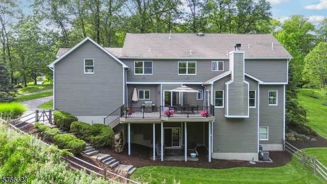 8 Forest Dr, Morris Twp, NJ 07960 - rear view of property with a deck, view of scattered trees, and a chimney