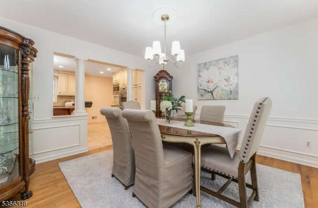 1 Craig Rd, Clinton Twp, NJ 08801 - dining space featuring decorative columns, a chandelier, and light wood finished floors