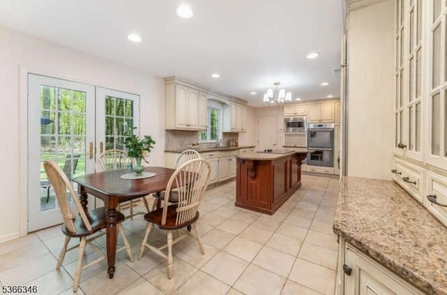1 Craig Rd, Clinton Twp, NJ 08801 - kitchen featuring appliances with stainless steel finishes, cream cabinets, recessed lighting, a chandelier, and a center island