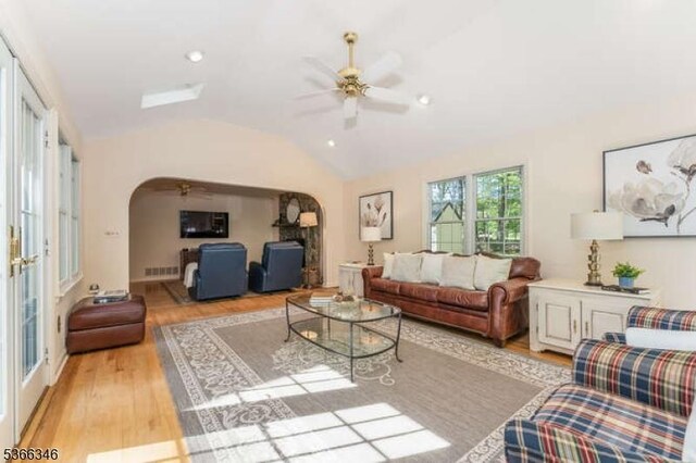 1 Craig Rd, Clinton Twp, NJ 08801 - living area featuring arched walkways, a ceiling fan, vaulted ceiling, and light wood-style floors