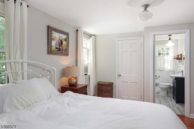 924 Maurice Ave, Rahway City, NJ 07065 - bedroom with multiple windows, wood finished floors, and ensuite bathroom