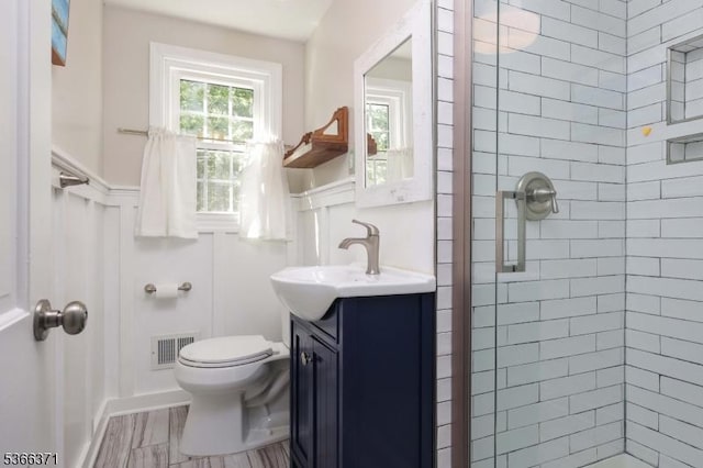 924 Maurice Ave, Rahway City, NJ 07065 - bathroom with a stall shower, vanity, a decorative wall, and wainscoting