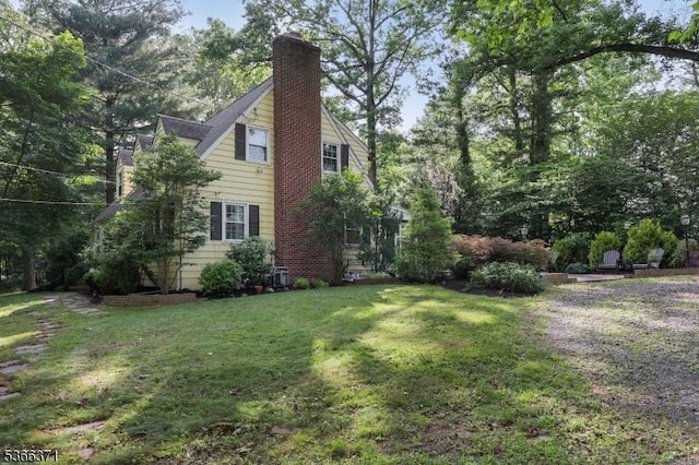924 Maurice Ave, Rahway City, NJ 07065 - view of side of home with a lawn and a chimney