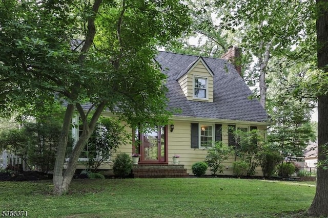 924 Maurice Ave, Rahway City, NJ 07065 - cape cod-style house with a chimney, a front yard, and a shingled roof