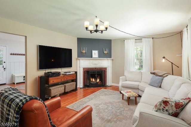 924 Maurice Ave, Rahway City, NJ 07065 - living room featuring a chandelier, wood finished floors, and a brick fireplace