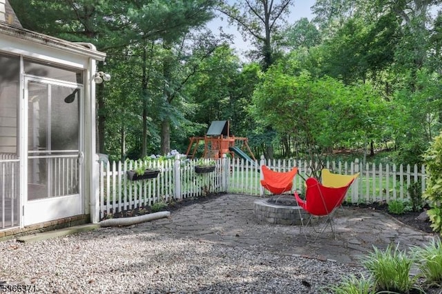 924 Maurice Ave, Rahway City, NJ 07065 - view of yard with a fire pit, a playground, and view of scattered trees