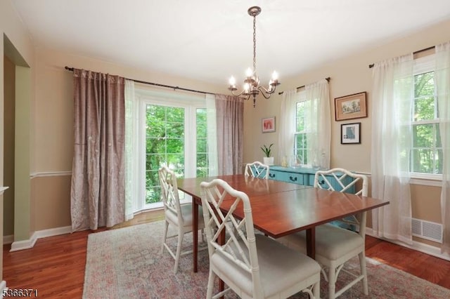 924 Maurice Ave, Rahway City, NJ 07065 - dining space with a chandelier, plenty of natural light, and wood finished floors
