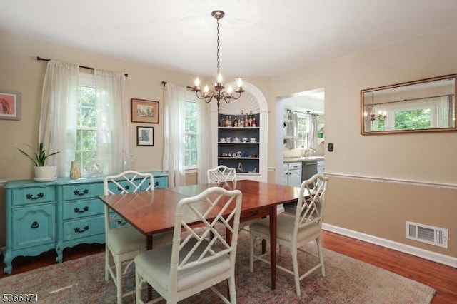 924 Maurice Ave, Rahway City, NJ 07065 - dining room featuring a chandelier and dark wood-style floors