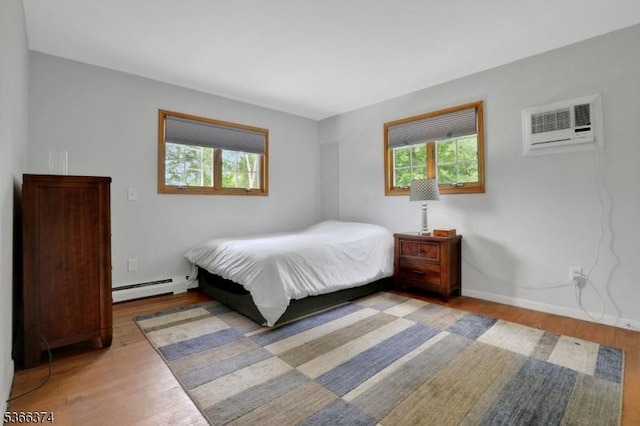11 Ayers Ci, Andover Twp, NJ 07860 - bedroom with baseboard heating, a wall unit AC, and wood finished floors