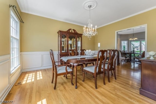 4 Coryell Ct, Raritan Twp, NJ 08822 - dining room with a chandelier, light wood finished floors, crown molding, and a wainscoted wall
