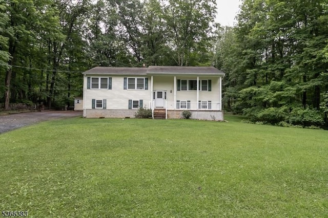 8 Ridge Rd, Independence Twp, NJ 07840 - bi-level home with a front lawn, covered porch, view of wooded area, and driveway