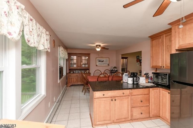 8 Ridge Rd, Independence Twp, NJ 07840 - kitchen with freestanding refrigerator, ceiling fan, a peninsula, a baseboard radiator, and light tile patterned floors