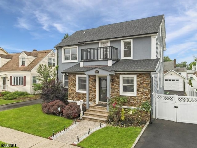 980 Moessner Ave, Union Twp, NJ 07083 - view of front of property with a balcony, driveway, roof with shingles, stone siding, and stucco siding