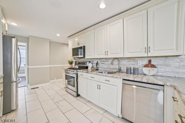 980 Moessner Ave, Union Twp, NJ 07083 - kitchen with appliances with stainless steel finishes, light marble finish floors, decorative backsplash, light stone countertops, and recessed lighting