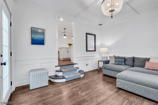913 Columbus Ave, Westfield Town, NJ 07090 - living room with crown molding, a decorative wall, wood finished floors, wainscoting, and a chandelier