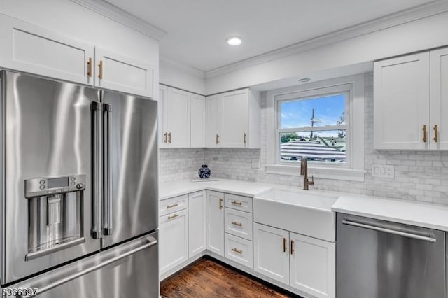 913 Columbus Ave, Westfield Town, NJ 07090 - kitchen with appliances with stainless steel finishes, ornamental molding, light countertops, white cabinets, and tasteful backsplash
