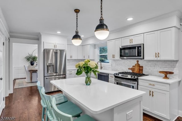 913 Columbus Ave, Westfield Town, NJ 07090 - kitchen featuring stainless steel appliances, white cabinetry, light countertops, a center island, and crown molding