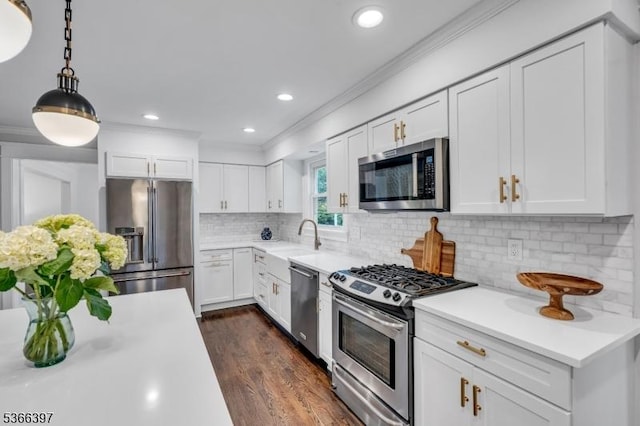 913 Columbus Ave, Westfield Town, NJ 07090 - kitchen featuring stainless steel appliances, light countertops, ornamental molding, white cabinets, and dark wood-type flooring