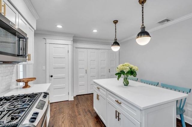 913 Columbus Ave, Westfield Town, NJ 07090 - kitchen with appliances with stainless steel finishes, crown molding, dark wood-style flooring, light countertops, and pendant lighting
