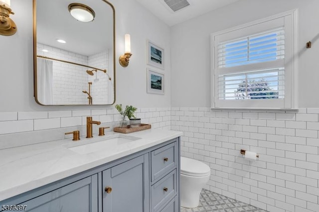 913 Columbus Ave, Westfield Town, NJ 07090 - bathroom with tile walls, vanity, a tile shower, a wainscoted wall, and tile patterned floors